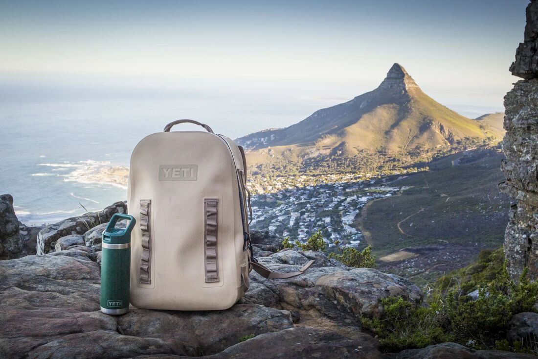 A daypack resting on a rocky overlook above Cape Town